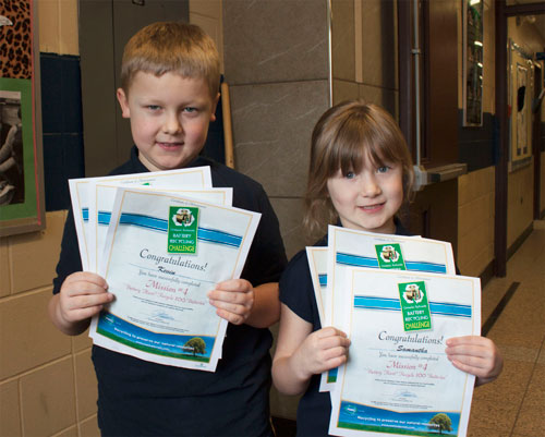 Kevin and Samantha receive battery recycling certificates for their environmental achievements! 